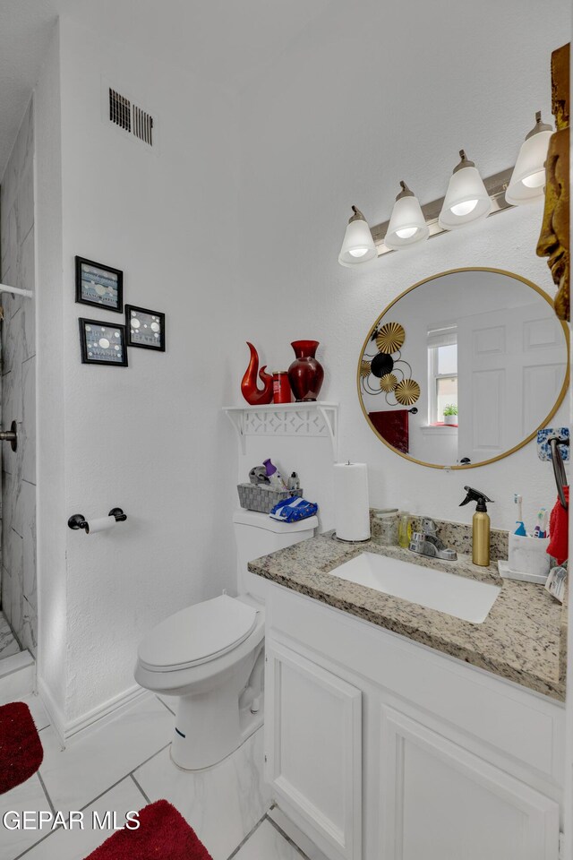 bathroom featuring a shower stall, visible vents, toilet, and vanity