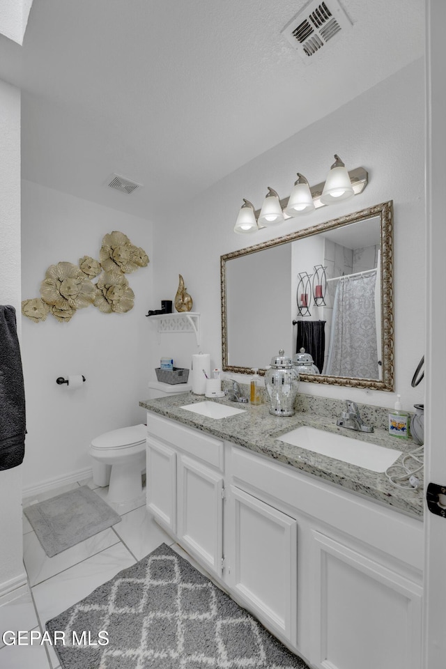 full bathroom featuring toilet, a sink, and visible vents