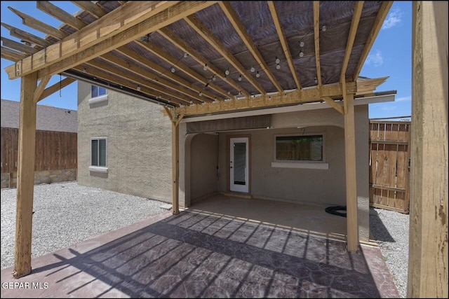 view of patio featuring fence