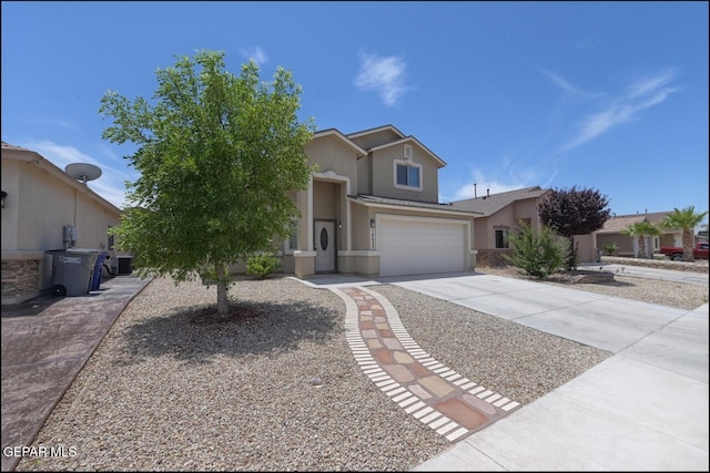 view of front of home with stucco siding, concrete driveway, and an attached garage
