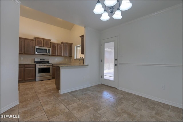 kitchen featuring a sink, a notable chandelier, appliances with stainless steel finishes, and baseboards