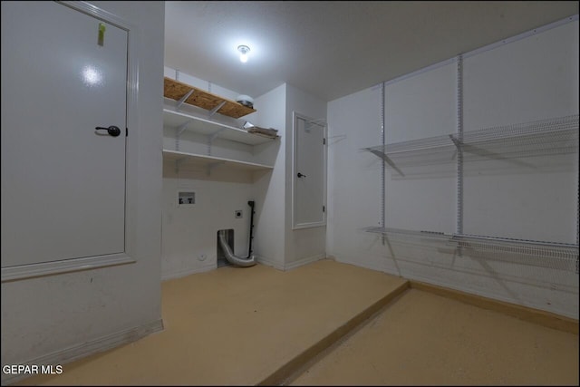 clothes washing area with hookup for a washing machine, electric dryer hookup, laundry area, and baseboards