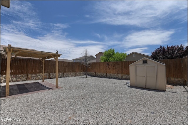 view of yard with a patio, an outdoor structure, a fenced backyard, and a storage shed