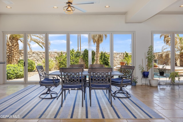 sunroom / solarium featuring stone tile flooring and recessed lighting