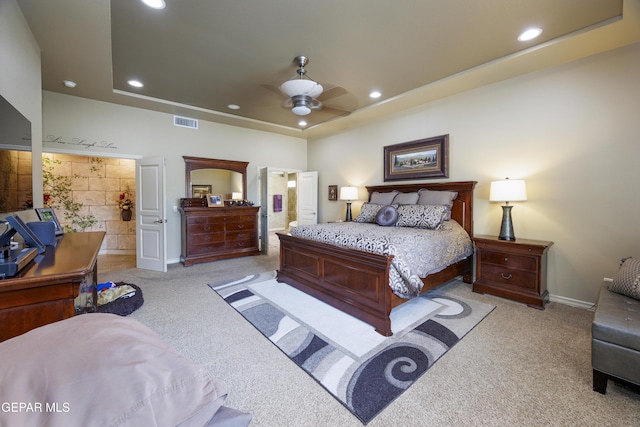bedroom with carpet floors, recessed lighting, and a raised ceiling
