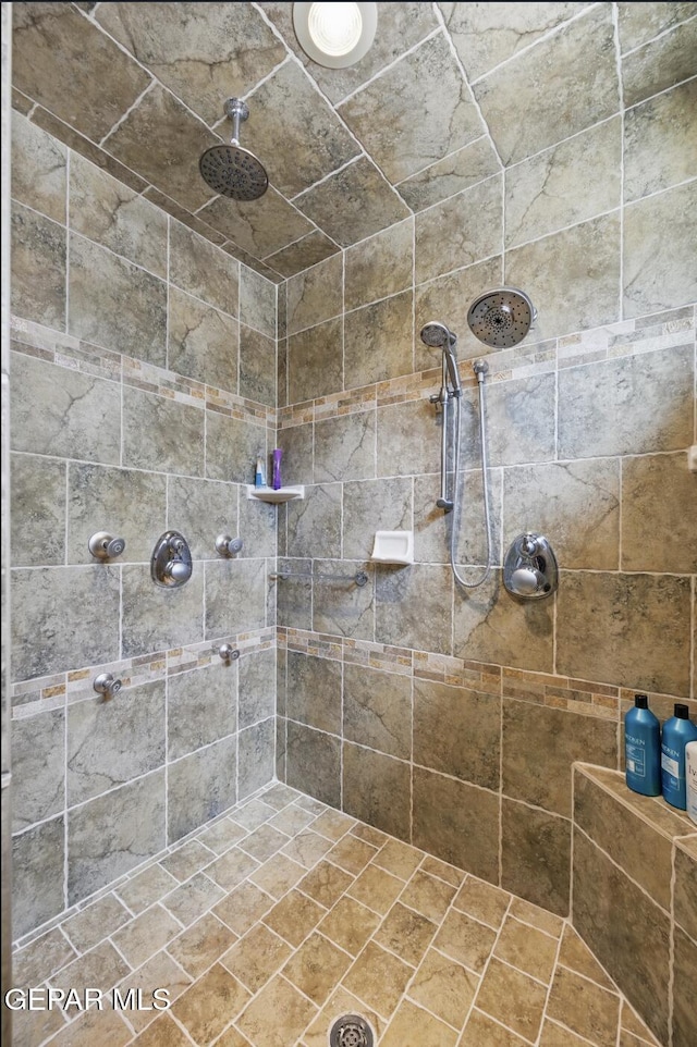 bathroom with tiled shower