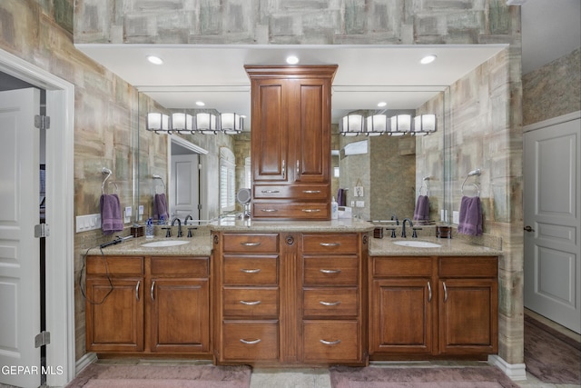 full bath with a sink and double vanity