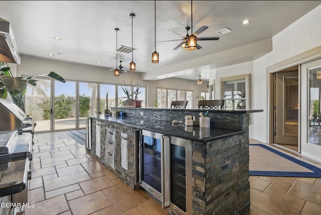 kitchen with stone tile floors, ceiling fan, visible vents, wine cooler, and recessed lighting