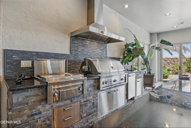 view of patio / terrace featuring an outdoor kitchen, visible vents, and a grill