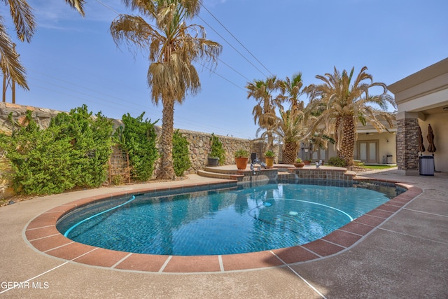 view of pool with a patio, a fenced in pool, and french doors