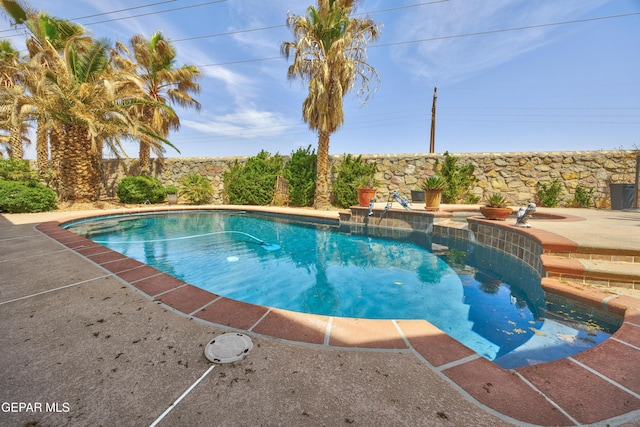 view of swimming pool with a patio and a fenced in pool