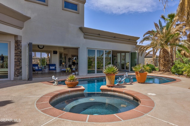 view of pool with a pool with connected hot tub and a patio