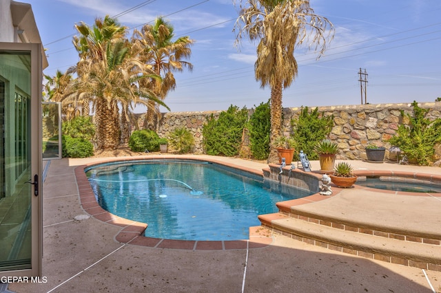 view of swimming pool with a fenced in pool, a patio, and an in ground hot tub