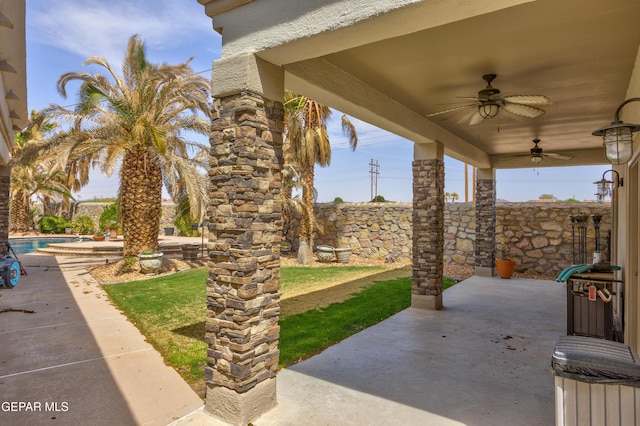 view of patio / terrace featuring fence, a ceiling fan, and a fenced in pool