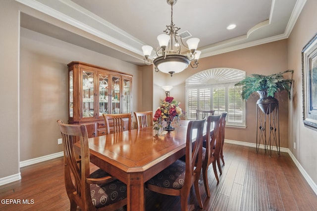 dining room with hardwood / wood-style floors, baseboards, and an inviting chandelier