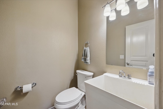 bathroom featuring toilet and vanity