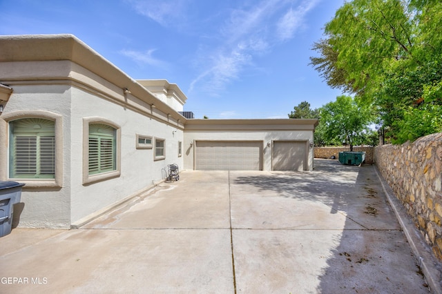 view of home's exterior featuring stucco siding, an attached garage, and concrete driveway