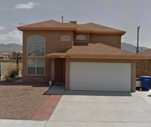 6236 Grace Madriles Pl, El Paso, TX 79932 - view of front of property featuring a garage, stucco siding, and concrete driveway