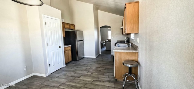 6236 Grace Madriles Pl, El Paso, TX 79932 - kitchen featuring baseboards, arched walkways, light countertops, and freestanding refrigerator