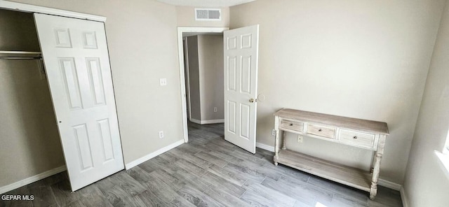 6236 Grace Madriles Pl, El Paso, TX 79932 - unfurnished bedroom with baseboards, wood finished floors, and visible vents