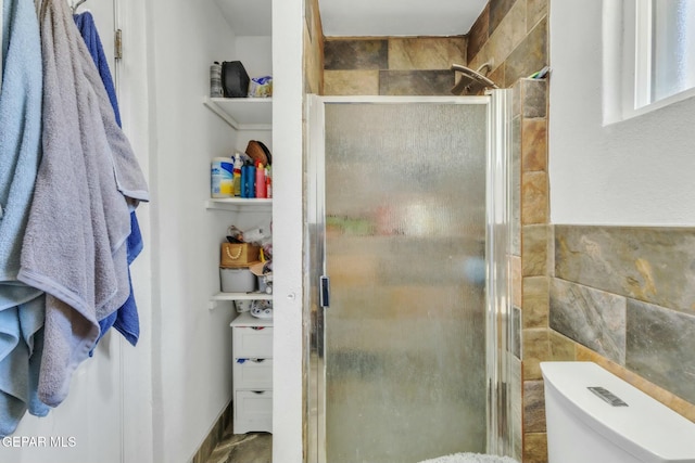 9966 Morocco Cir, El Paso, TX 79927 - bathroom with tile walls, a shower stall, and toilet