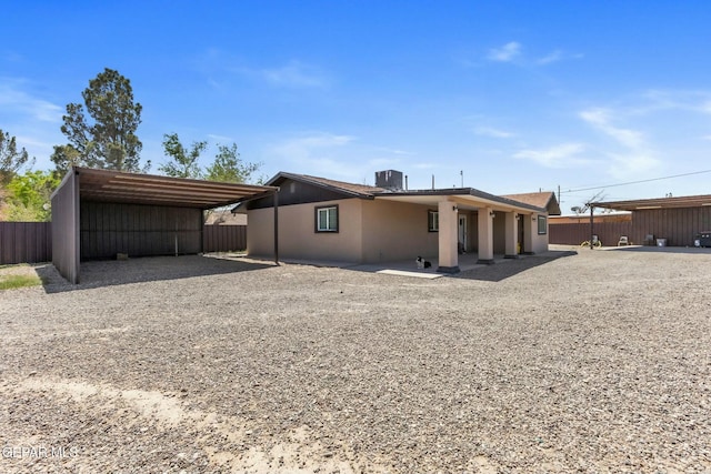 9966 Morocco Cir, El Paso, TX 79927 - back of house featuring fence, driveway, a carport, and central AC