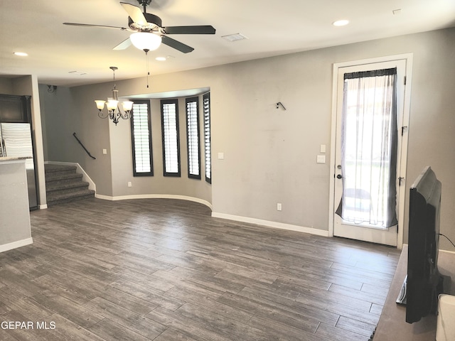 unfurnished living room with dark wood-style flooring, a chandelier, a ceiling fan, baseboards, and recessed lighting