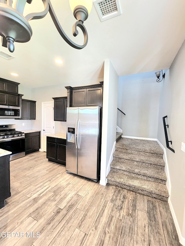 kitchen with stainless steel appliances, light wood-style floors, light countertops, baseboards, and recessed lighting
