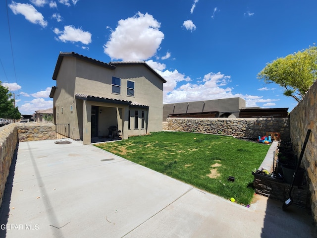 rear view of property featuring a patio area and stucco siding