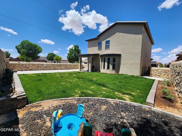 back of property featuring stucco siding