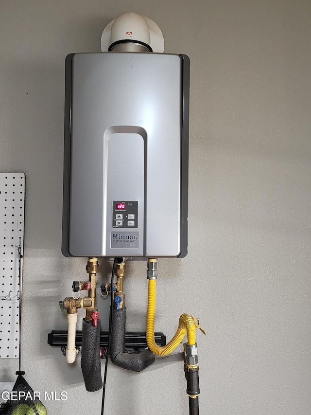 utility room featuring water heater