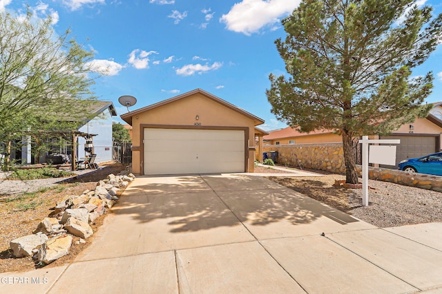 14310 Pacific Point Dr, El Paso, TX 79938 - view of front of home with stucco siding, a garage, and driveway