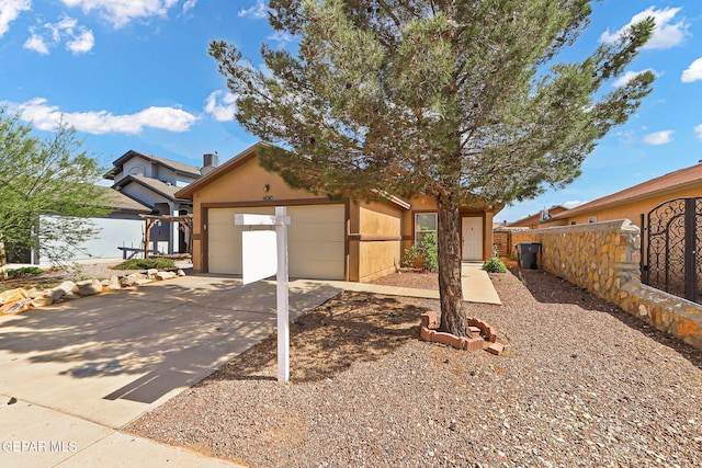 14310 Pacific Point Dr, El Paso, TX 79938 - view of front of house with concrete driveway, an attached garage, and stucco siding