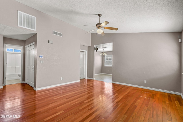 14310 Pacific Point Dr, El Paso, TX 79938 - spare room featuring a ceiling fan, a textured ceiling, wood finished floors, baseboards, and a chandelier