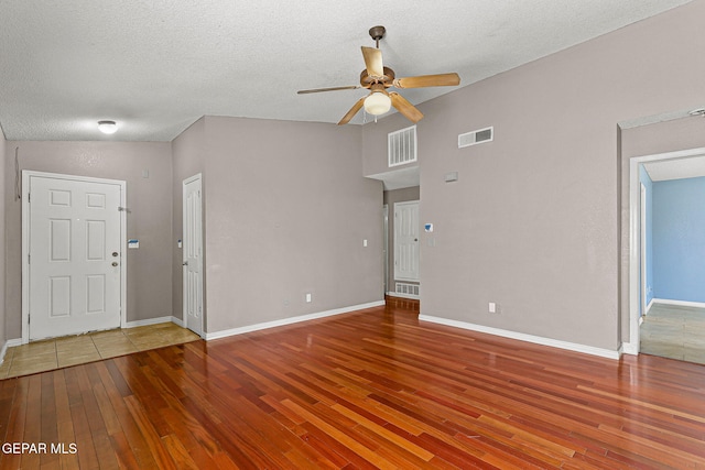 14310 Pacific Point Dr, El Paso, TX 79938 - unfurnished living room featuring a ceiling fan, hardwood / wood-style flooring, baseboards, and a textured ceiling