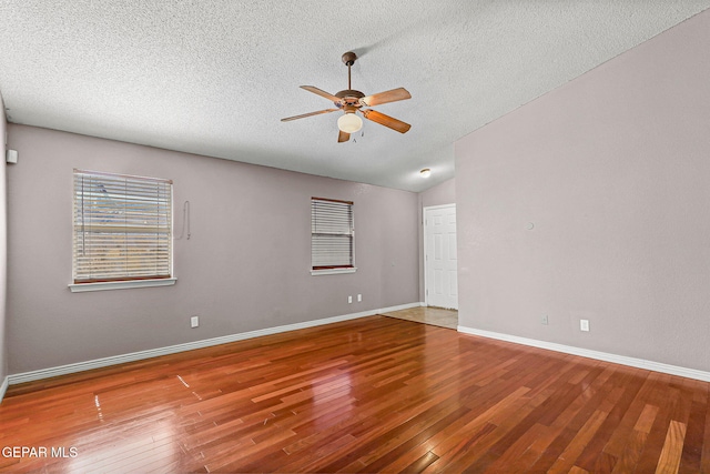 14310 Pacific Point Dr, El Paso, TX 79938 - spare room with ceiling fan, a textured ceiling, wood finished floors, lofted ceiling, and baseboards