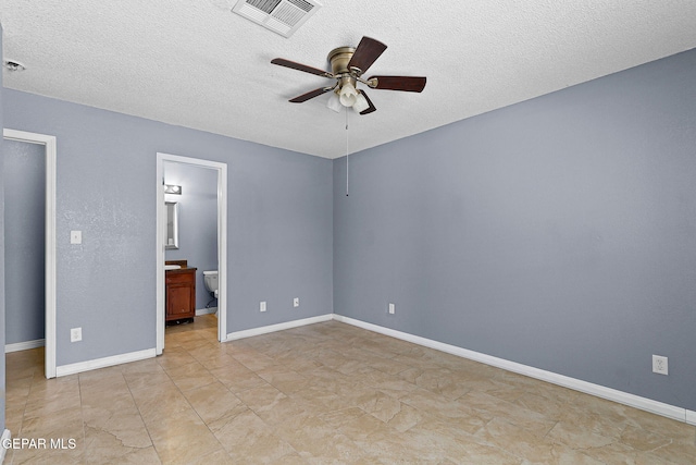 14310 Pacific Point Dr, El Paso, TX 79938 - unfurnished bedroom featuring a textured ceiling, baseboards, ensuite bath, and ceiling fan