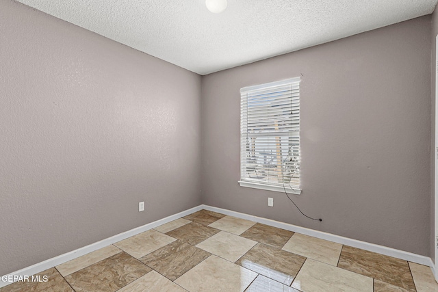14310 Pacific Point Dr, El Paso, TX 79938 - unfurnished room with baseboards and a textured ceiling