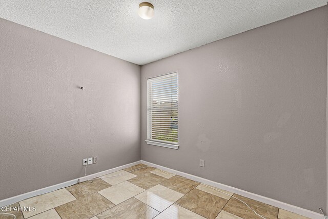 14310 Pacific Point Dr, El Paso, TX 79938 - unfurnished room with baseboards, a textured ceiling, and a textured wall