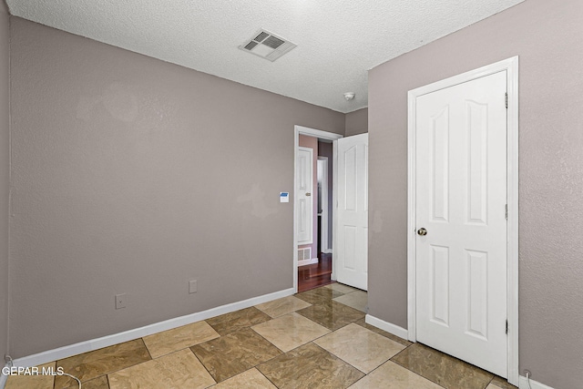 14310 Pacific Point Dr, El Paso, TX 79938 - unfurnished bedroom featuring baseboards and a textured ceiling