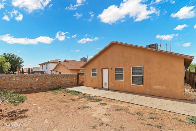 14310 Pacific Point Dr, El Paso, TX 79938 - rear view of house with a fenced backyard, central AC unit, a patio, and stucco siding