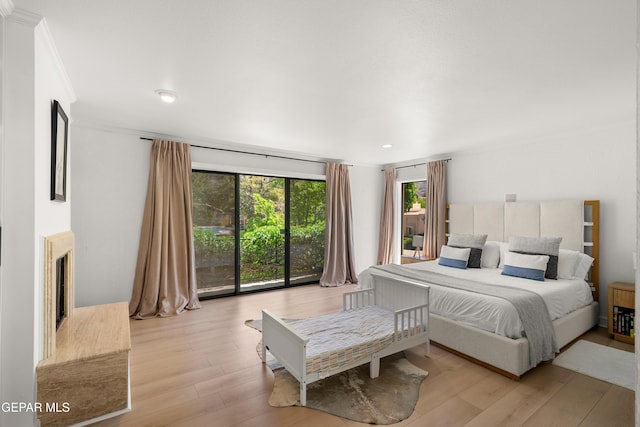 bedroom with recessed lighting, light wood-style flooring, and ornamental molding