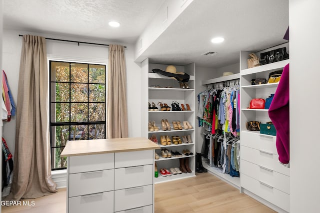walk in closet with light wood-style floors and visible vents