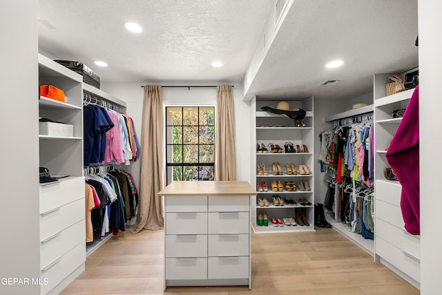 walk in closet with light wood-style floors and visible vents
