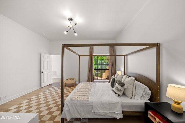 bedroom with wood finished floors and crown molding