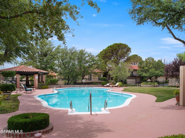 community pool featuring a gazebo, a patio area, and fence