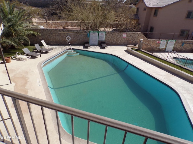 pool featuring a patio and fence