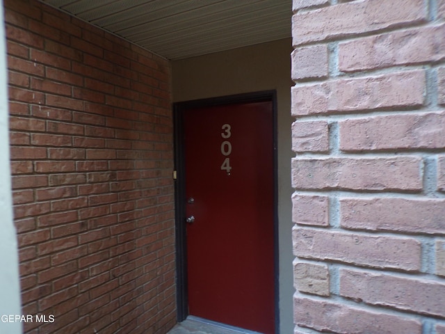property entrance with brick siding
