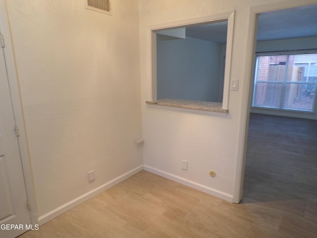empty room with baseboards and visible vents