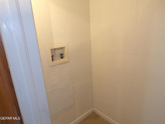 laundry area featuring washer hookup and baseboards